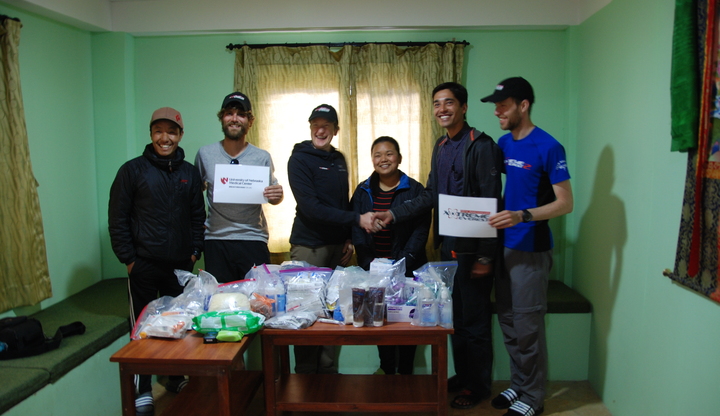 Dan, Kay and Andy from Xtreme Everest and University of Nebraska Medical Center hand over donations to the clinic staff